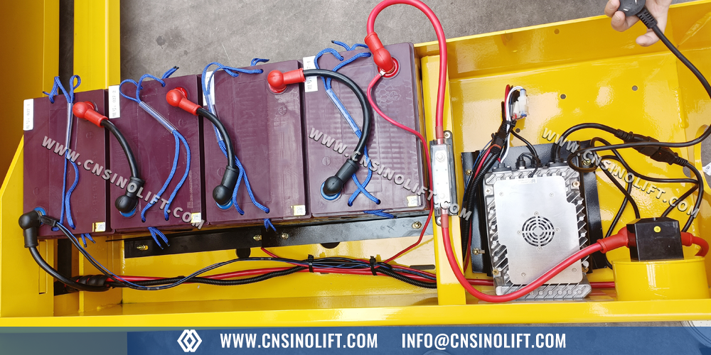 SINO LIFT electric scissor lift battery compartment detail showing maintenance-free battery configuration